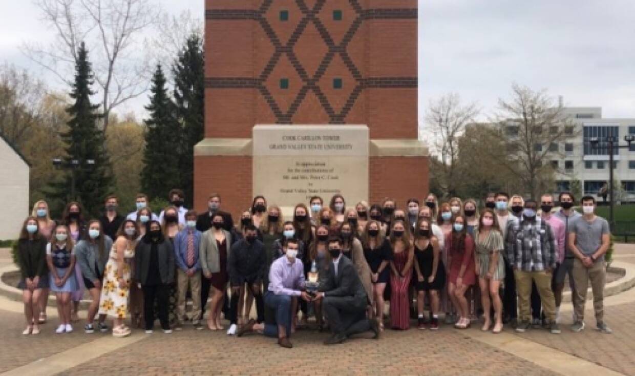 Rowing team poses in front of clocktower following banquet.
